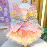 Colorful fairy costume with wings on a mannequin against a floral background