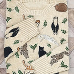 Folded sweater with animal pattern on a wooden surface