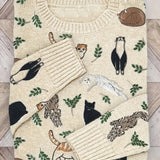 Folded sweater with animal pattern on a wooden surface