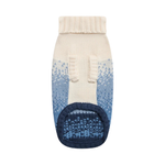 A single knit pet bootie sock shown flat against a solid white background. The bootie features an off-white ribbed cuff, a cream-to-blue gradient upper with a Fair Isle pattern, and a dark navy blue sole.