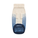 A single knit pet bootie sock shown flat against a solid white background. The bootie features an off-white ribbed cuff, a cream-to-blue gradient upper with a Fair Isle pattern, and a dark navy blue sole.