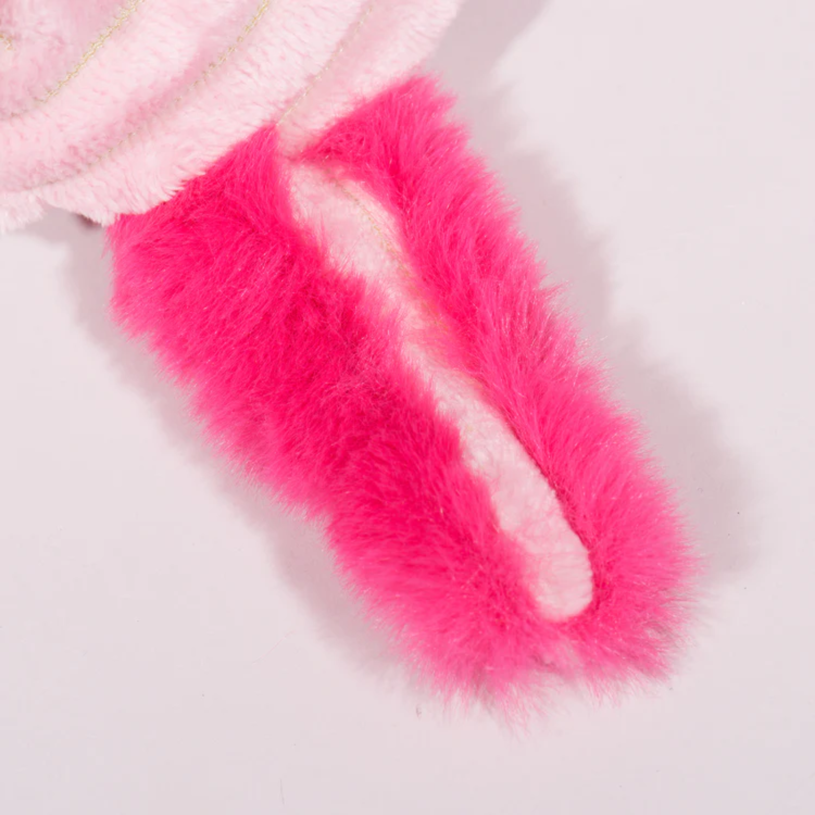 Close-up of pink and white fuzzy fabric on a light gray background