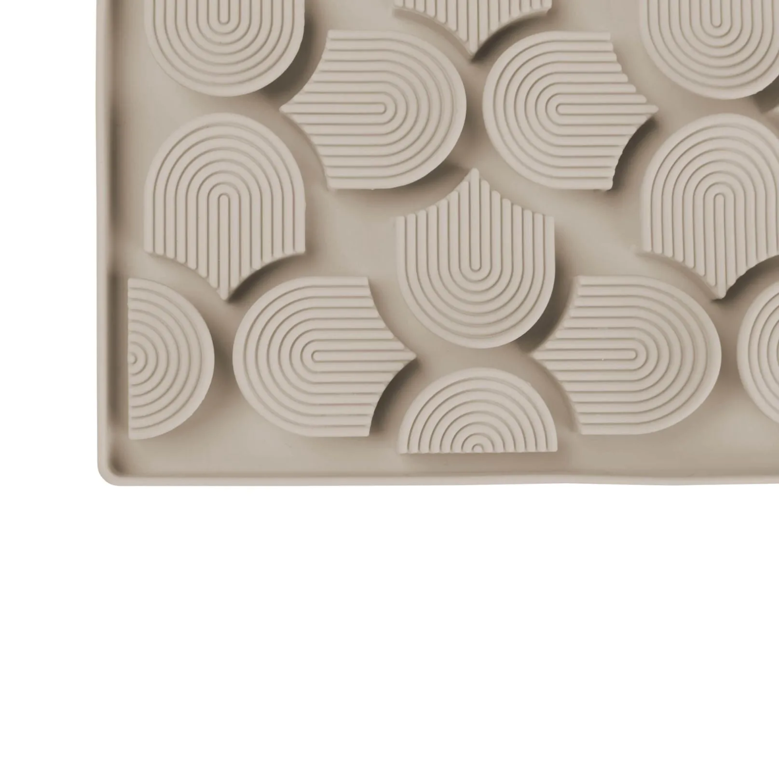 Beige silicone mold with geometric pattern on a white background