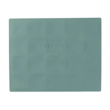 Teal placemat with 'Fuzzyard Life' branding on a white background