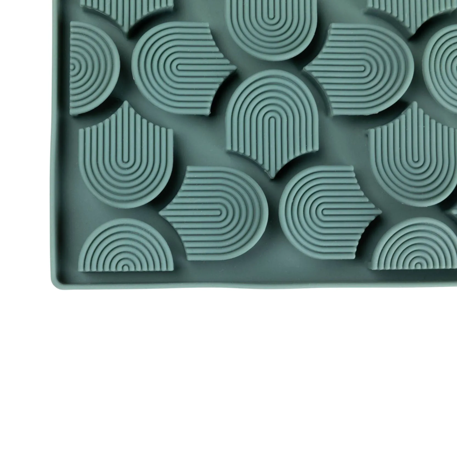 Green silicone mold with geometric patterns on a white background
