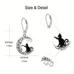 Earrings with cat and moon design, shown with measurements on a white background