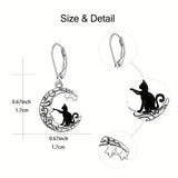 Earrings with cat and moon design, shown with measurements on a white background