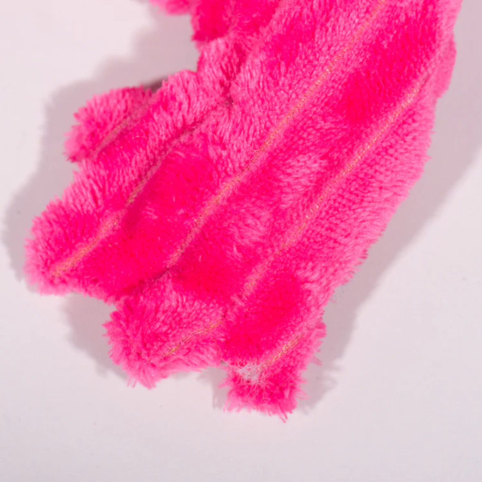 Close-up of pink fluffy fabric on a light background