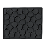Black textured mat with geometric pattern on a white background