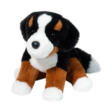 Plush toy dog with black, brown, and white fur on a white background