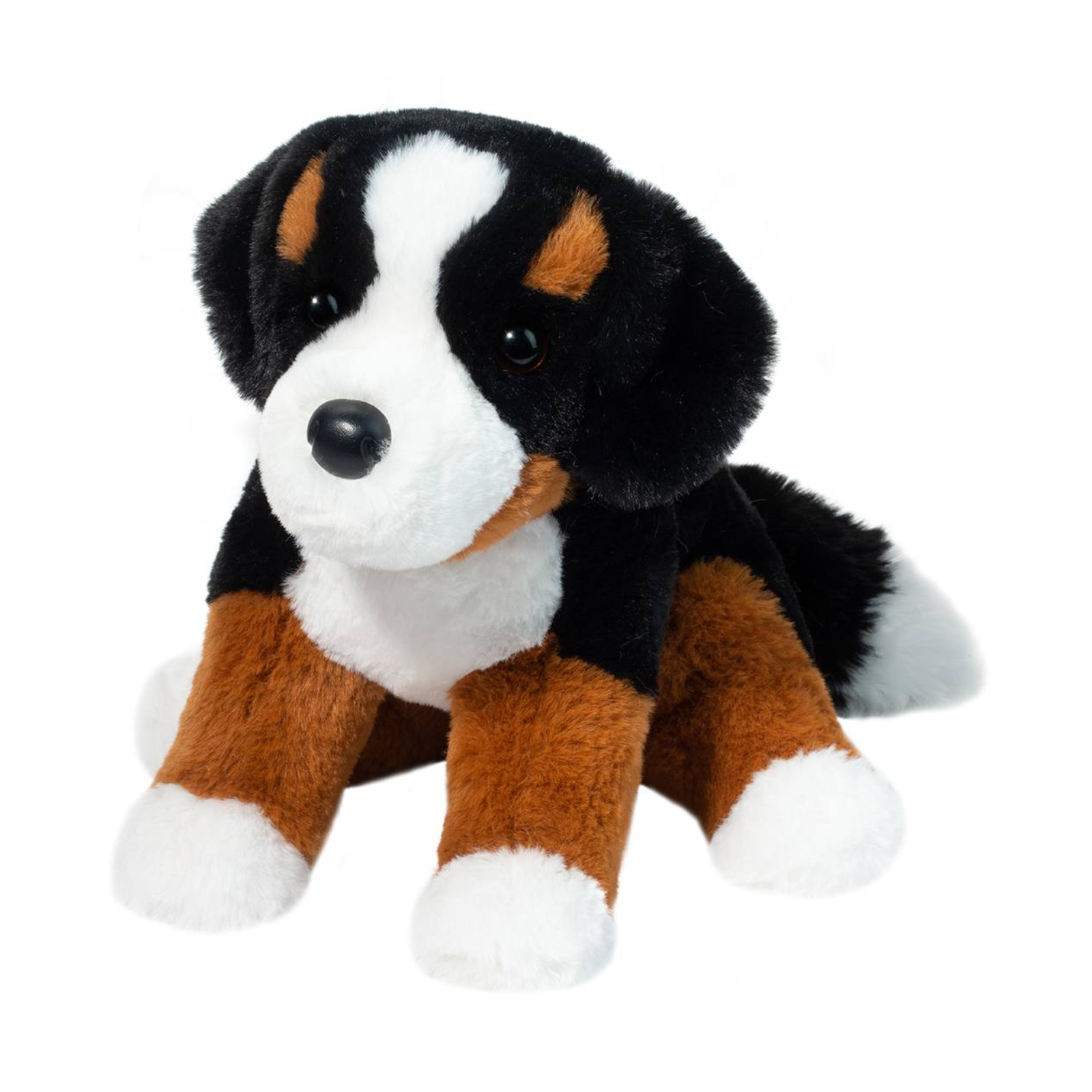 Plush toy dog with black, brown, and white fur on a white background
