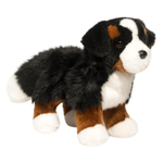 Plush toy dog with black, brown, and white fur on a white background