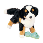Plush toy dog with a bone on a white background
