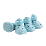 Light blue pet boots with straps on a white background