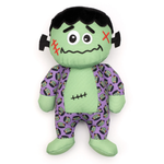 Plush toy resembling a character with green skin, black hair, and purple patterned outfit on a white background