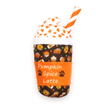 A plush toy shaped like a Pumpkin Spice Latte cup, featuring a dark brown patterned body with orange, yellow, and white fall-themed illustrations, an orange sleeve with white text reading 'Pumpkin Spice Latte' and small paw prints, a white whipped cream top with orange spots, and an orange-and-white striped straw, all on a plain white background.