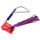Purple leather cat toy with a red tag on a white background