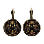 Pair of earrings with a black cat design on a white background