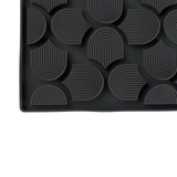 Black textured mat with geometric pattern on a white background