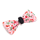 Pink bow hair clip with cherry pattern on a white background