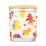 Candle with a wooden lid and leaf pattern on a white background