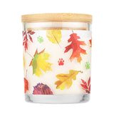 Candle with a wooden lid and leaf pattern on a white background