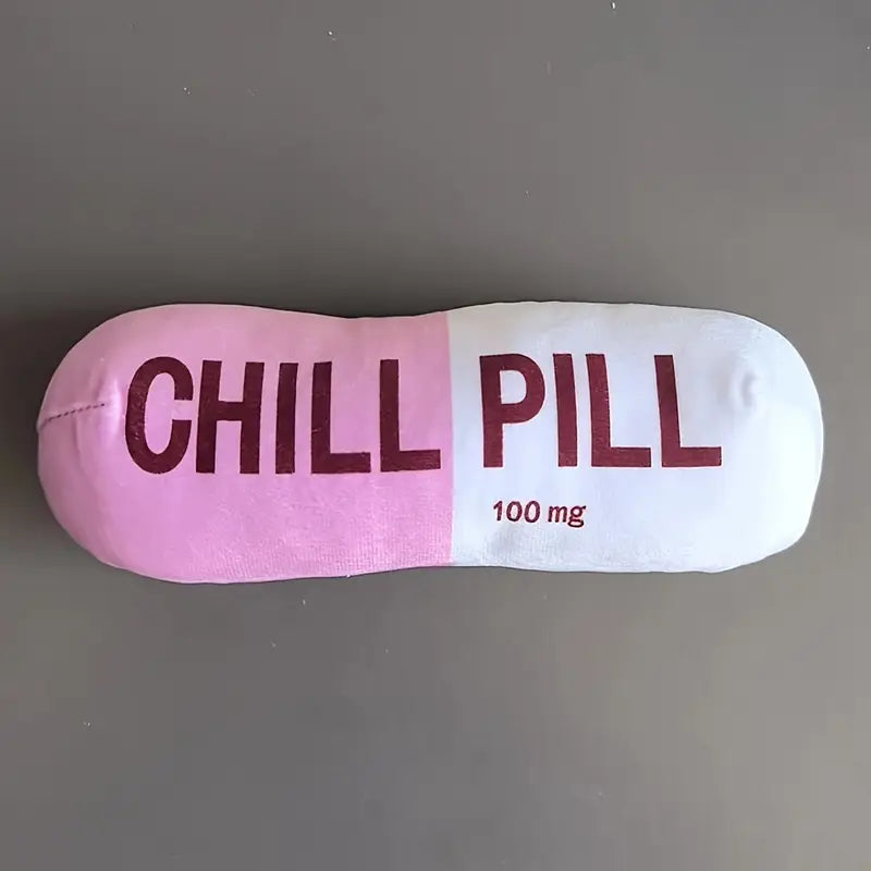 Pillow shaped like a pill with 'CHILL PILL' text on a gray background