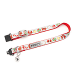 A festive Christmas-themed pet collar with a white base, red trim, and holiday illustrations including candy canes, snow globes, Santa Claus, and a bell. It features a silver metal buckle, a silver D-ring, and a small silver bell.