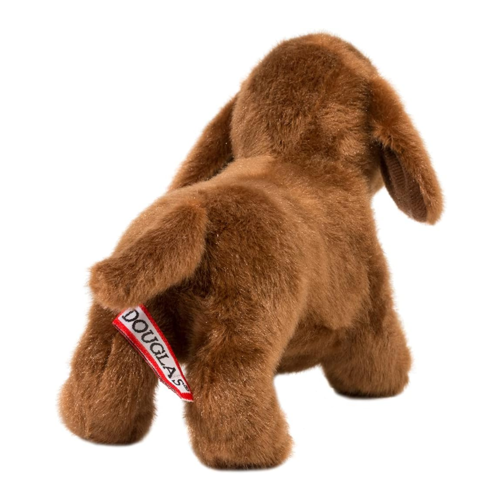 Brown plush dog toy with a visible brand tag on a white background