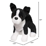 Black and white stuffed dog toy with measurements on a white background
