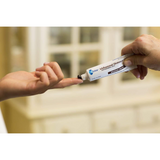 Hand applying a tube of Olay product to another hand with a blurred background