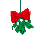 A plush Christmas mistletoe ornament by Kong, featuring a green felt leafy body with white button eyes, a large red plush bow, and a green hanging loop, shown on a plain white background.