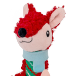 A plush toy shaped like a stylized deer or fox head with bright red curly hair, a pale pink face, black embroidered nose and eyes, and a light blue scarf with a green patterned lower section, shown on a plain white background.