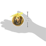Measurement of a round object with a yellow ribbon held by a hand on a white background