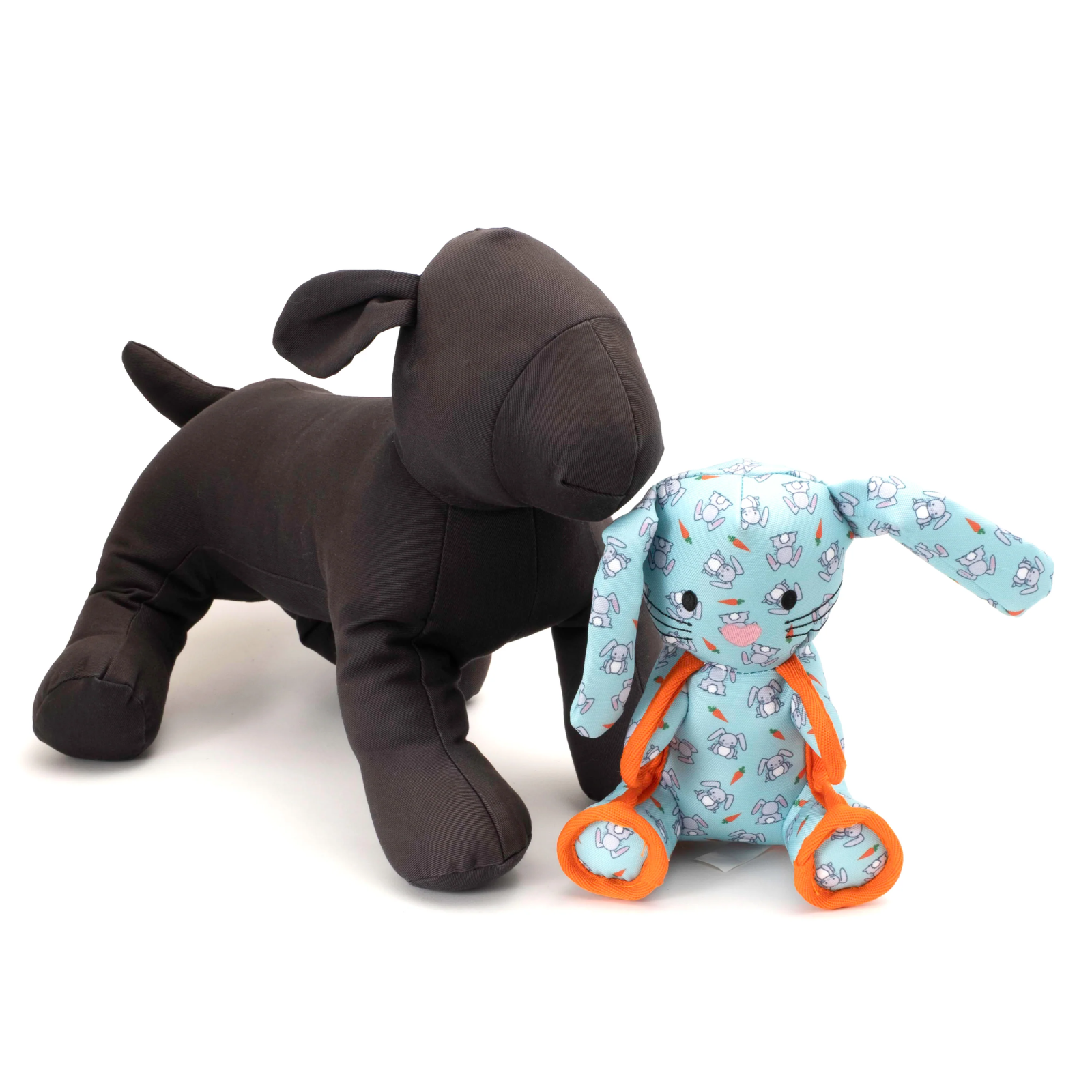 Two plush dog toys on a white background: one solid dark brown and one light blue with a bunny print and orange rings.