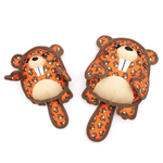 Two orange beaver plush toys with a brown and black patterned print, cream-colored snout and belly, and dark brown outlines, displayed on a solid white background.