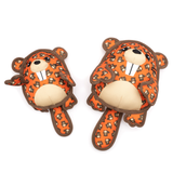 Two orange beaver plush toys with a brown and black patterned print, cream-colored snout and belly, and dark brown outlines, displayed on a solid white background.