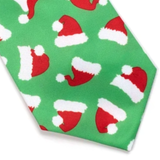 A close-up of a green necktie featuring a repeating pattern of red and white Santa hats, shown against a plain white background.