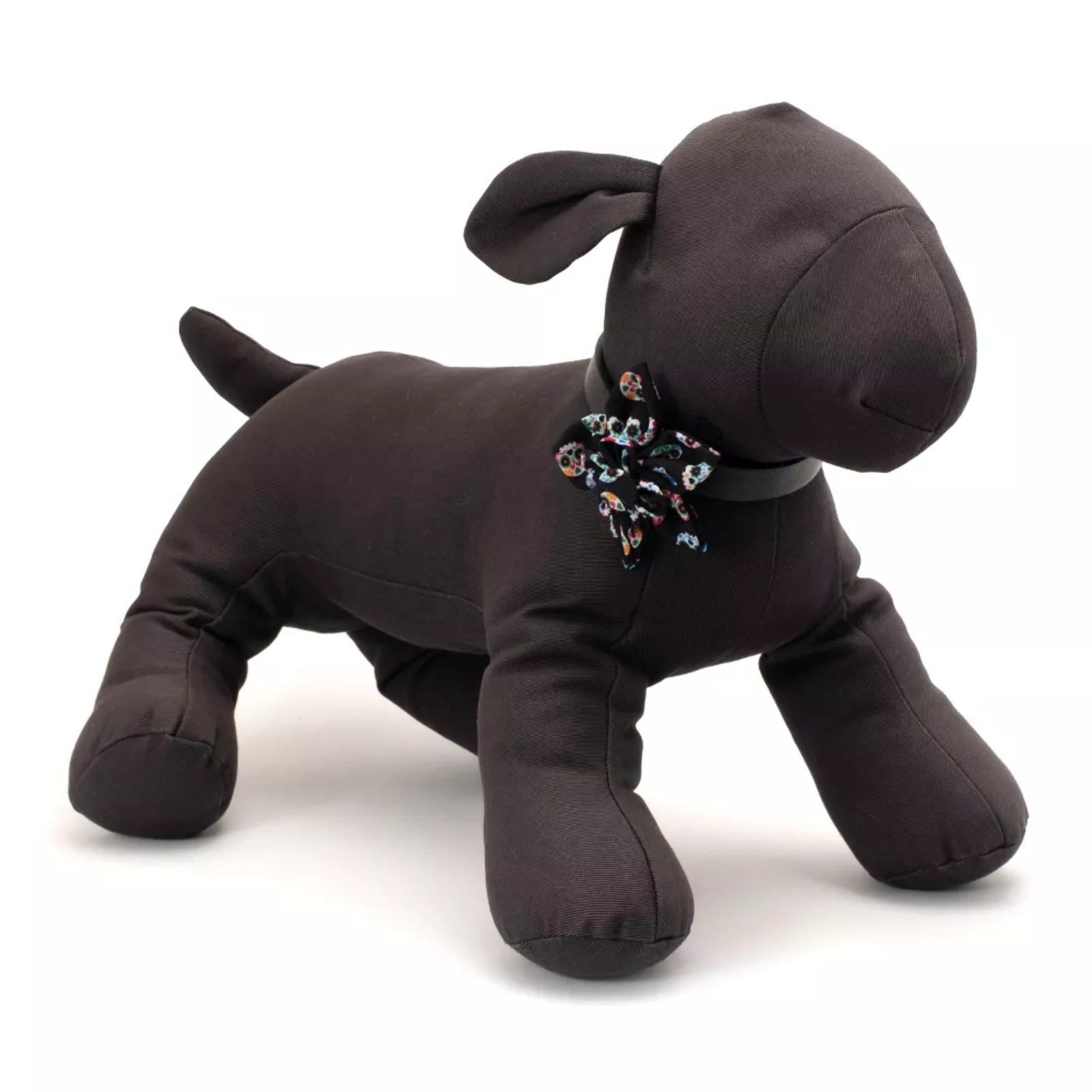 Brown plush dog toy with a floral-patterned bow tie on a white background