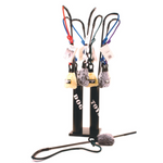 Collection of dog toys on a stand with various leashes and accessories.