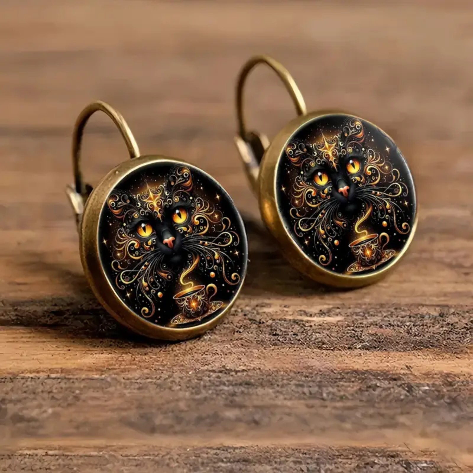 Pair of earrings with intricate designs on a wooden surface