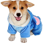 Dog wearing a blue onesie with a hood on a white background