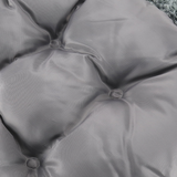Close-up of a gray cushion with button details
