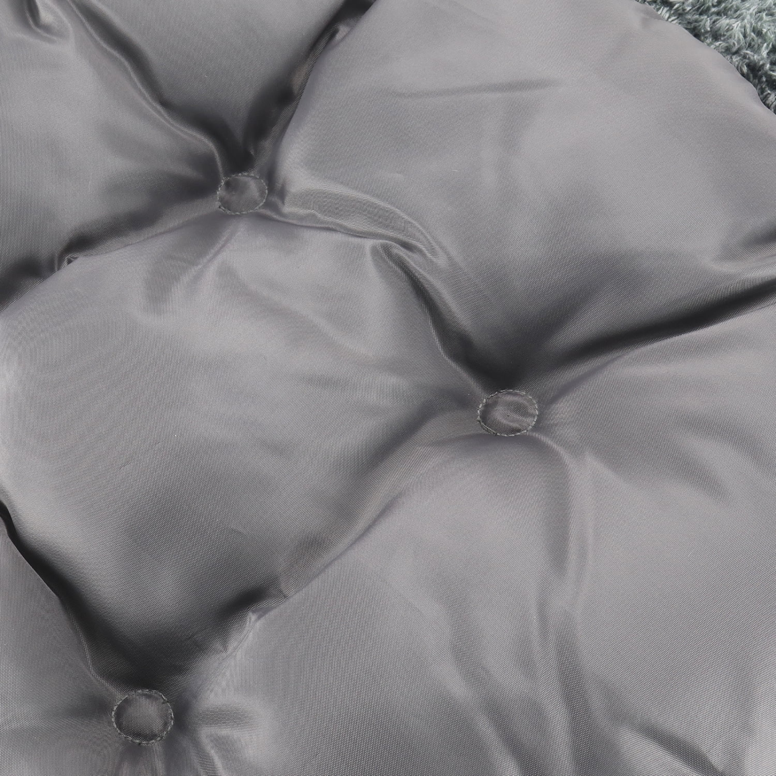 Close-up of a gray cushion with button details