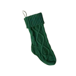Green knitted Christmas stocking on a white background
