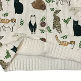 Patterned fabric with animal illustrations and a knitted blanket on top