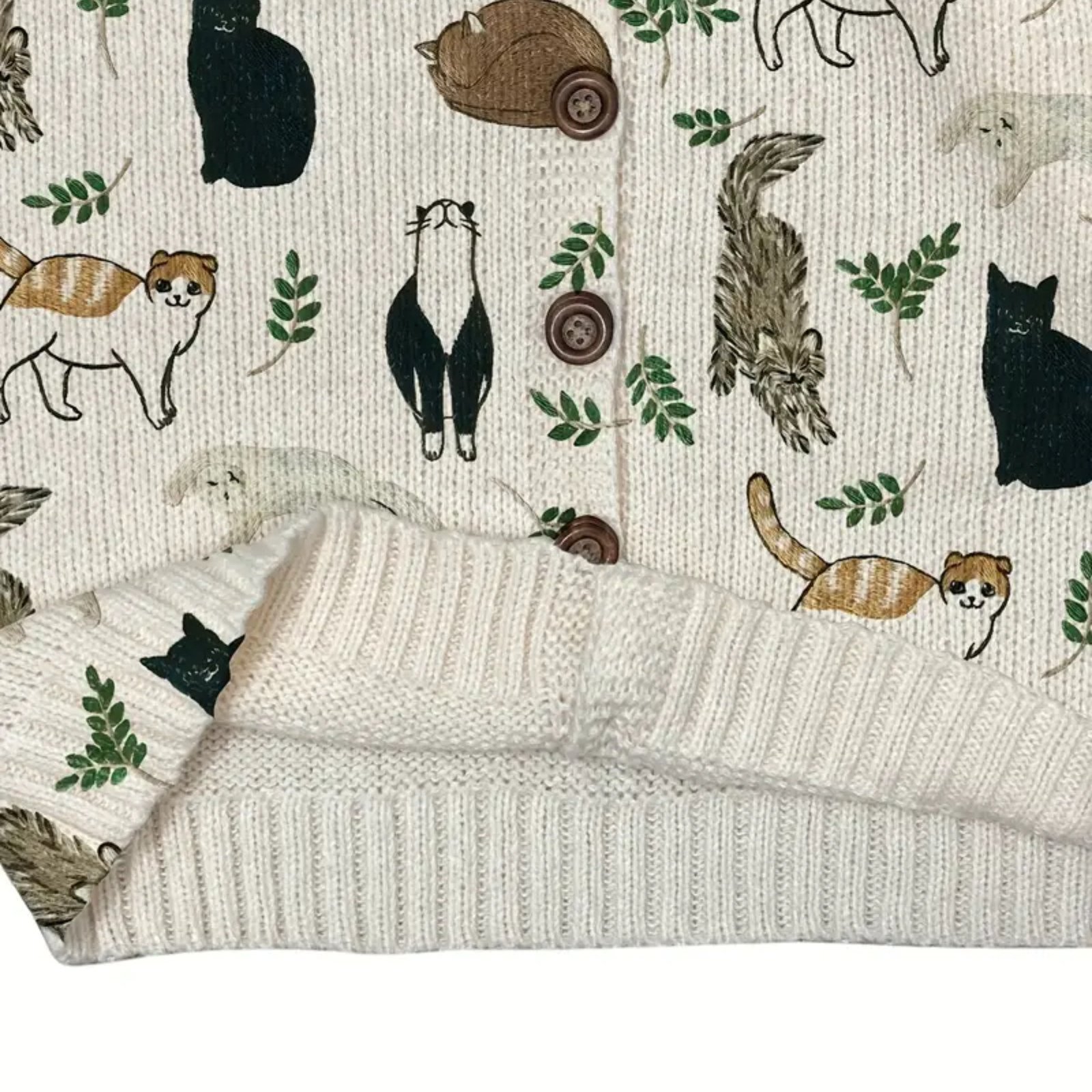 Patterned fabric with animal illustrations and a knitted blanket on top