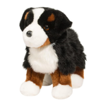 Plush toy dog with black, brown, and white fur on a white background
