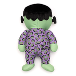 Plush toy resembling a character with green skin and purple outfit on a white background