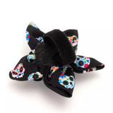 Black hair bow with colorful floral patterns on a white background